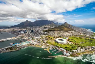Aerial view of Cape Town, South Africa with development on coast and mountains in background