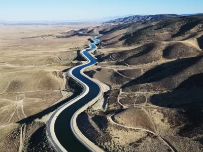 Aerial view of California aqueduct snaking through arid hills outside Los Angeles