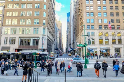 People at a busy New York City intersection crosswalk.