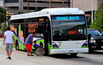 People boarding a bus on Maryland's Orange Route.