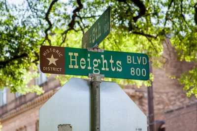 Close-up of green street sign at Heights Blvd and 8th Street in Houston, Texas with "Historic District" and star logo