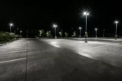 Asphalt parking lot at night with bright lights