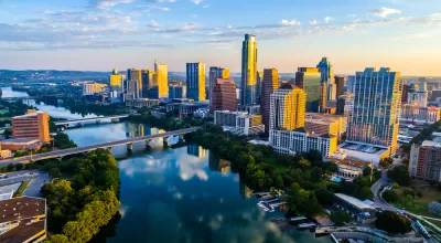 Aerial view at dusk of downtown Austin, Texas with river in foreground
