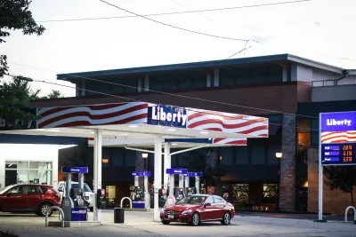 Gas station named Liberty painted with red and white US flag stripes with red cars at gas pump in Bethesda, Maryland.