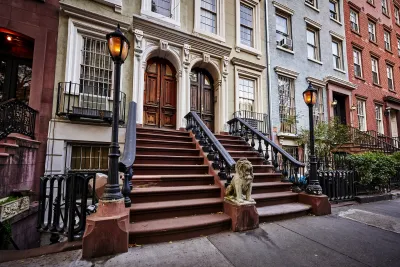 Close-up on stoop in row of elegant New York City brownstone homes.