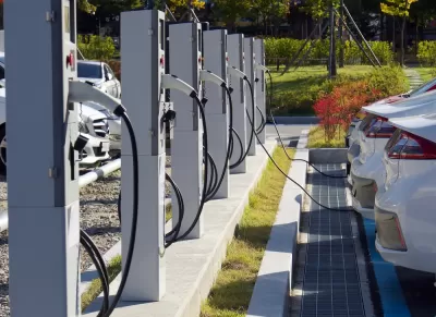 Electric vehicle charging station with white cars plugged in