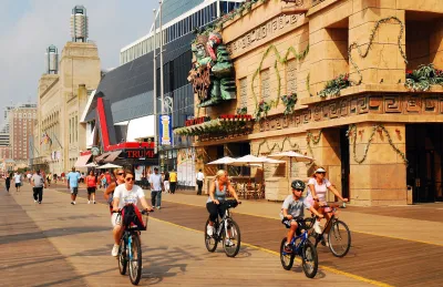 People riding bikes onboardwalk in Atlantic City, New Jersey.
