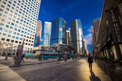 Pedestrians walking in downtown Denver, Colorado surrounded by tall office towers