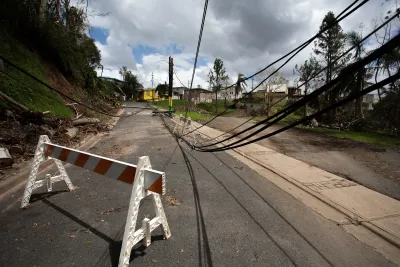 Downed power lines in road in Puerto Rico after a hurricane.