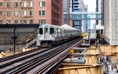 CHicago elevated train passing by brick buildings