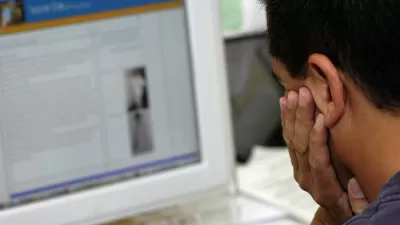 man looking at computer screen 