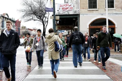 Busy crosswalk with pedestrians on small street in Austin, Texas.