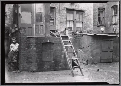 Rear of tenements with young boy: Manhattan