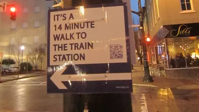 street sign in Raleigh showing length of walk to train station