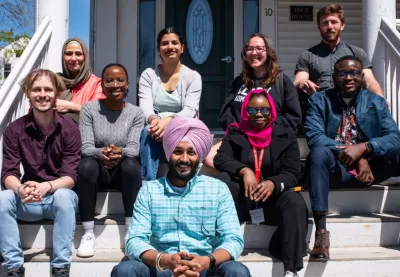 Picture of students sitting on steps smiling