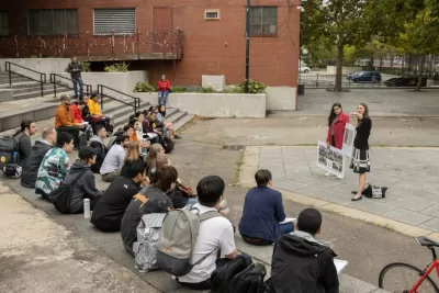 Boston University Campus stairs with students sitting and watching a presentation