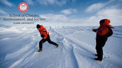 Image of two people out in the snow wearing red and black jackets and Clark University's logo in the upper left hand corner