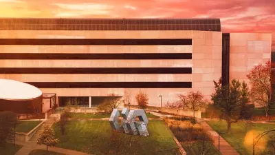 Iowa State University image of outside building with monocrome color with a grassy area and an abstract statue in the middle
