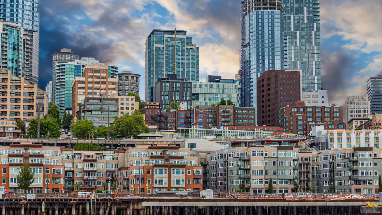 View of dense apartment buildings on Seattle waterfront with high-rise buildings in background.