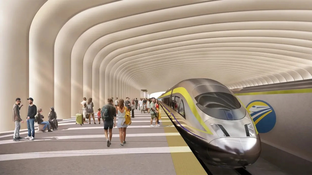 A rendering of a high speed rain station in California, with wide platforms and a sleep train with yellow highlights.