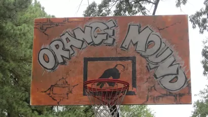 The backboar of a basketball hoop is painted orange with the words "orange Mound"--the name of a historically black neighborhood in Memphis, Tennessee.