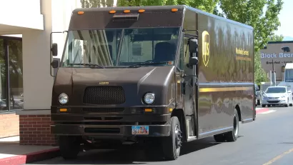 UPS delivery truck parked by urban sidewalk