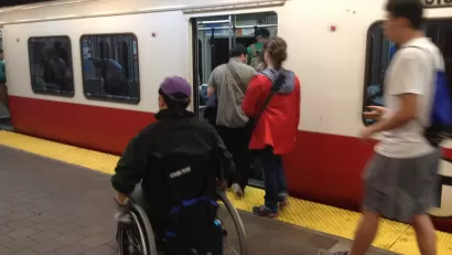  Person in a wheelchair entering an inbound Red Line train at Harvard Square