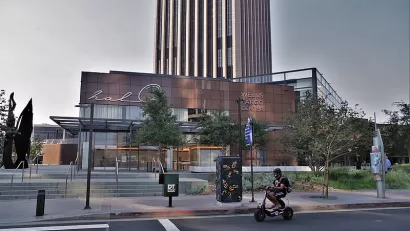 Young man cruises on by on an empty Grand Ave. in the heart of Los Angeles.