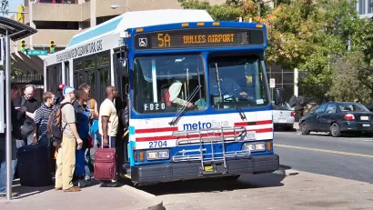 Passengers lined up to board city bus in Washington, D.C. to Dulles Airport
