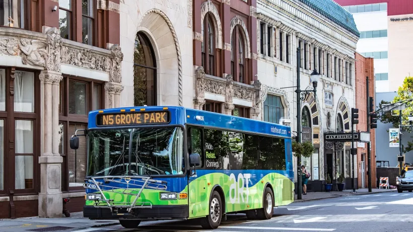 Green and blue Asheville public transit bus.