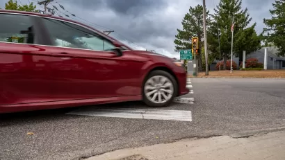 Red car turning right on red light.