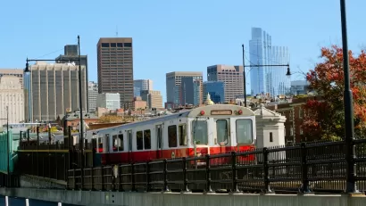 Boston Red Line train with skyline in background.