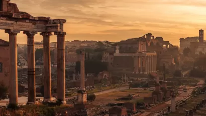 Roman Forum ruins in Rome, Italy with dusk sky.