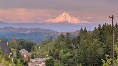 View of Mount Hood at golden hour with Happy Valley, Oregon homes in foreground.