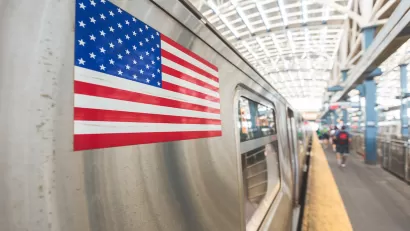 Close-up of American flag sticker on a silver subway train.