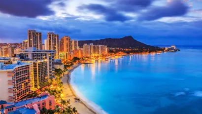 Aerial view of Honolulu, Hawaii coastline at dusk.
