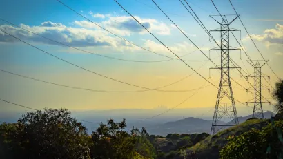 Power lines at golden hour with downtown Los Angeles in far background.