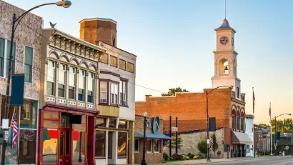 Commercial street in small rural U.S. town with storefronts and clocktower.