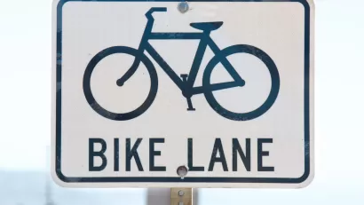 Close-up of 'bike lane' road sign with bike logo
