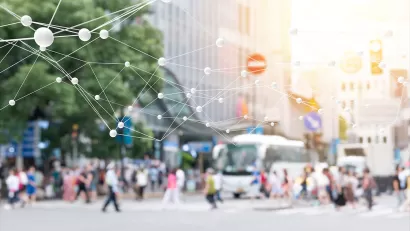 Blurred image of pedestrians on busy street with 'smart city' network rendering superimposed.