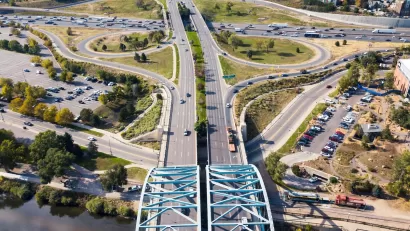 Aerial view of wide roadway and arc bridge in Denver, Colorado.