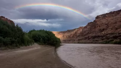 Rainbow over red rocks and river in Utah's Labyrinth Canyon.