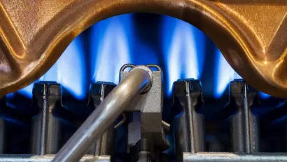 Close-up of blue flame in gas-powered water heater.