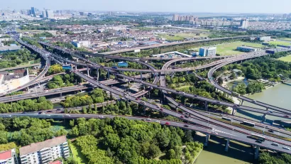 Aerial view of five-level freeway interchange in Houston, Texas with bridges spanning green bayou.