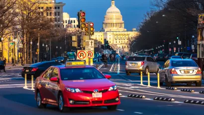 Traffic on Pennsylvania Avenue with U.S. Capitol dome in background