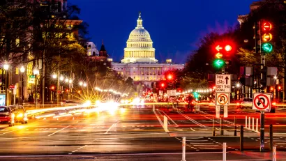 Nighttime view of U.S. Capitol and blurred traffic on Pennsylvania Avenue