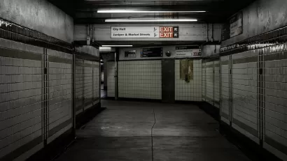 Empty hallway lined with white tile in subway station in Philadelphia, Pennsylvania.