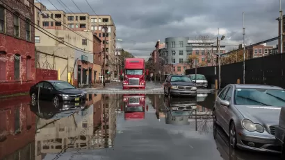 Cars passing through flooded street after Hurricane Sandy in New York City.