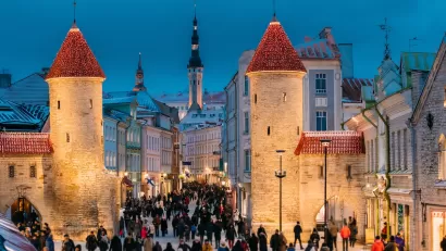 Crowd of people walking around Viru Gate medieval towers in Tallinn, Estonia.