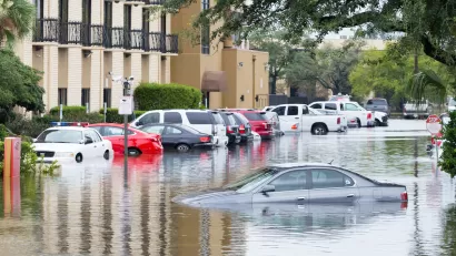 Flooded Houston street with half-submerged cars during Hurricane Harvey.